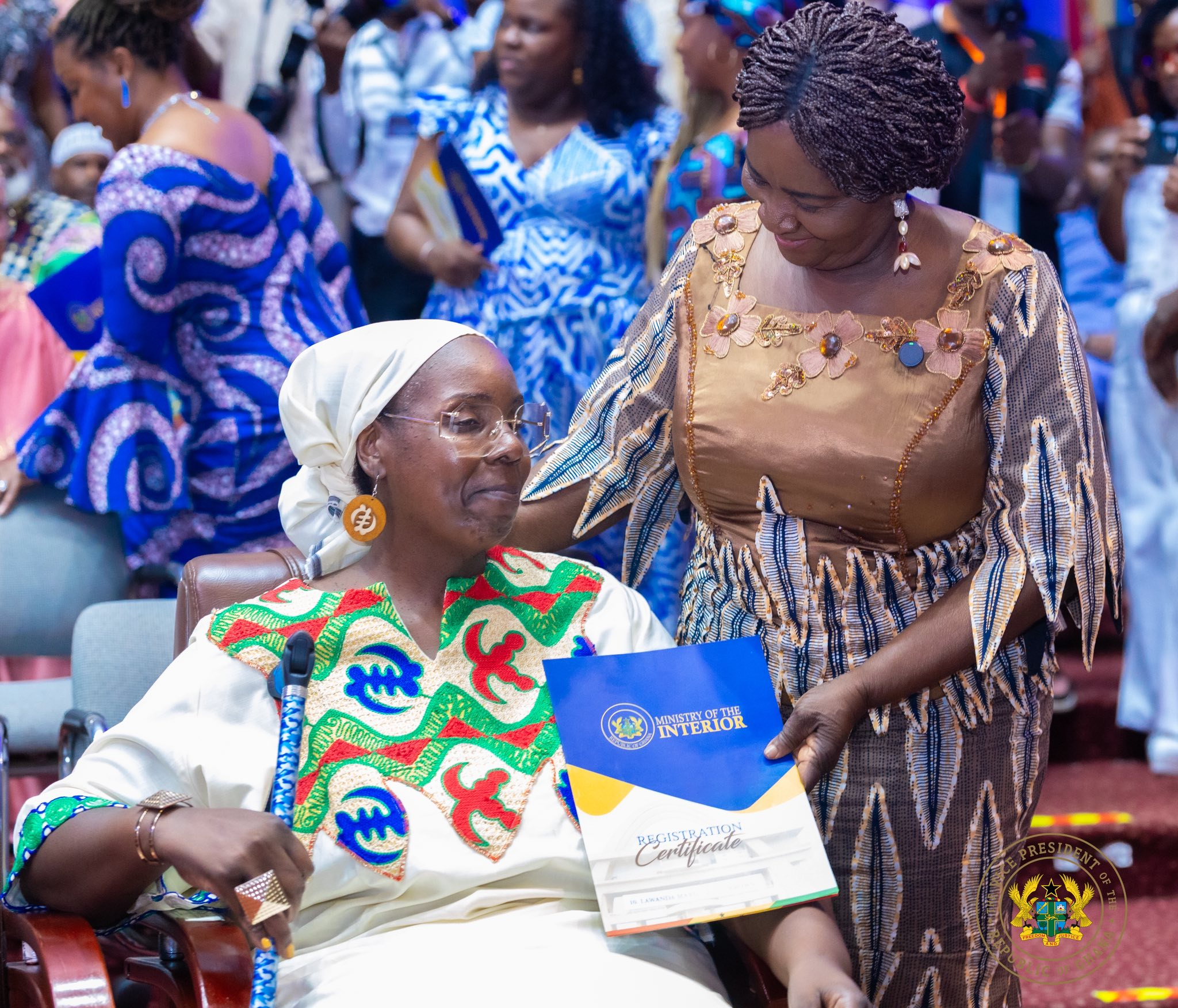 Figure 1: Vice President,  Jane Naana Opoku-Agyemang hands over a registration certificate of citizenship to one of the new citizens
